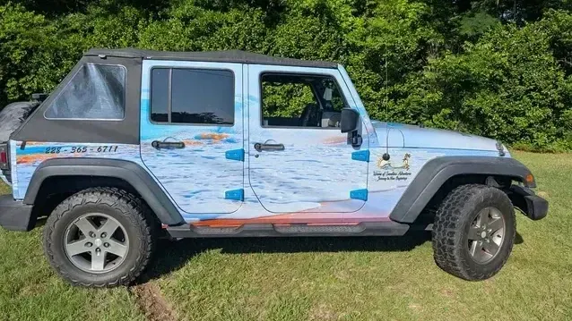 Jeep wrapped by Rooster Graphics and Designs for Waves of Sunshine Adventures