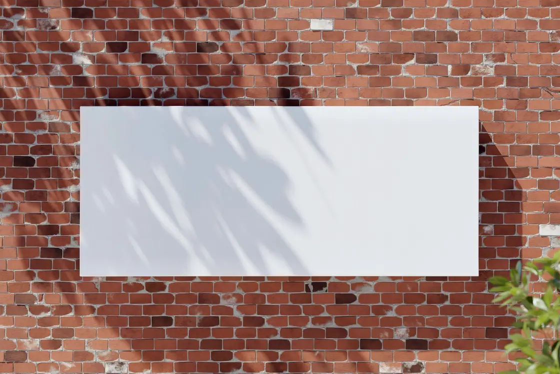 Blank white banner mounted on a red brick wall