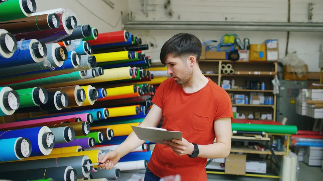 Racks of coloured vinyl rolls in a sign workshop